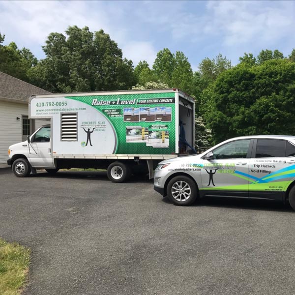 Concrete slab jacking service vehicles parked at a residential property before a repair project in Leesburg, VA Homes