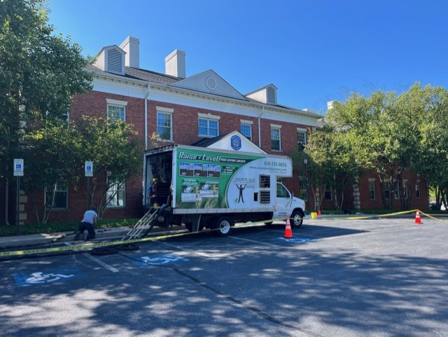Concrete slab jacking service truck set up outside a commercial building for a concrete leveling project in Sterling, VA Homes.